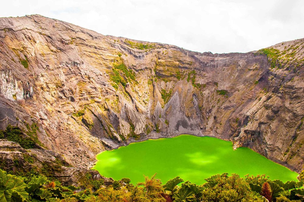 irazu volcano crater with some cloulds on top
 - Costa Rica