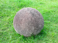        costa rica stone sphere on the grass at finca 
  - Costa Rica